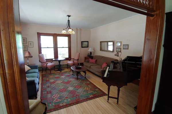 living room with couches and piano